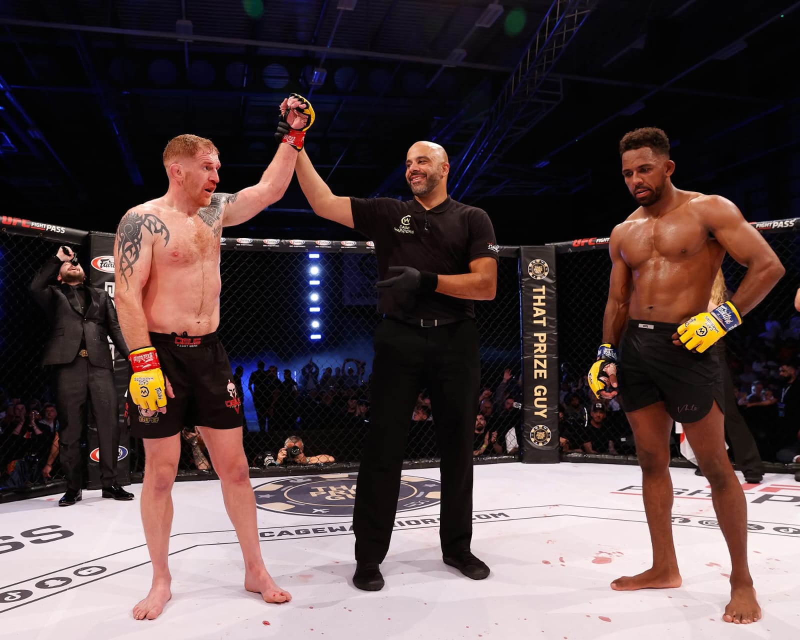 Andrew Fisher having his hand raised after winning at Cage Warriors Newcastle