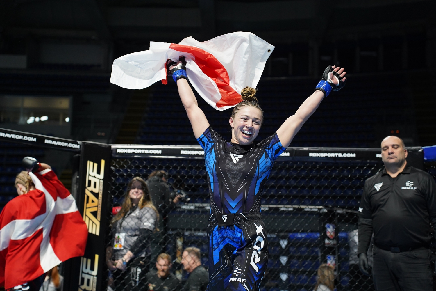 Katrina Fisher celebrating abroad with the England flag after her IMMAF victory