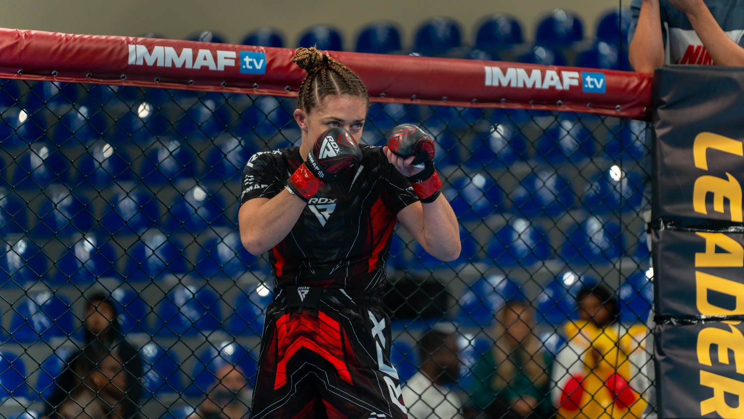 Katrina Fisher preparing to compete inside the IMMAF cage