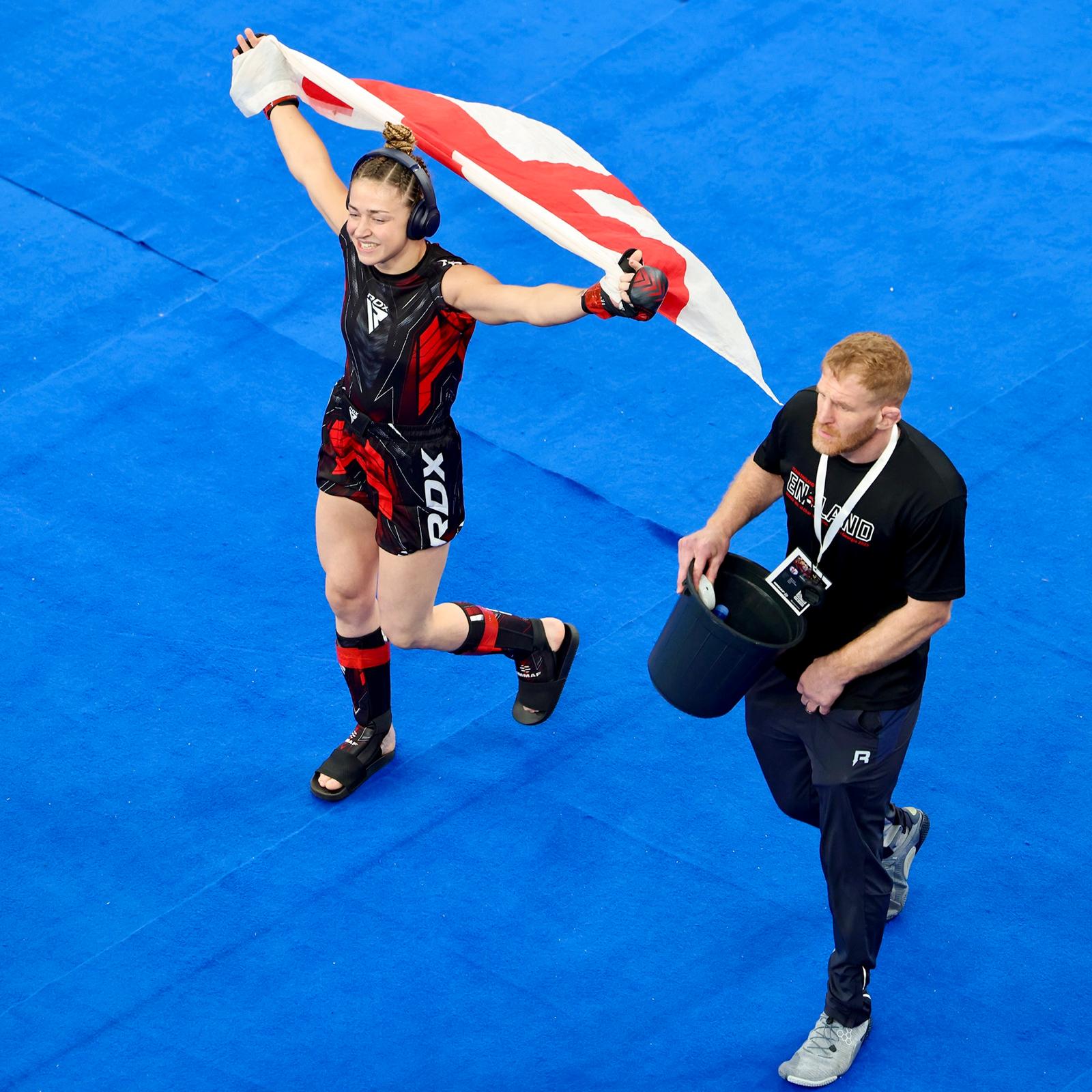 Katrina Fisher carrying the England flag at IMMAF